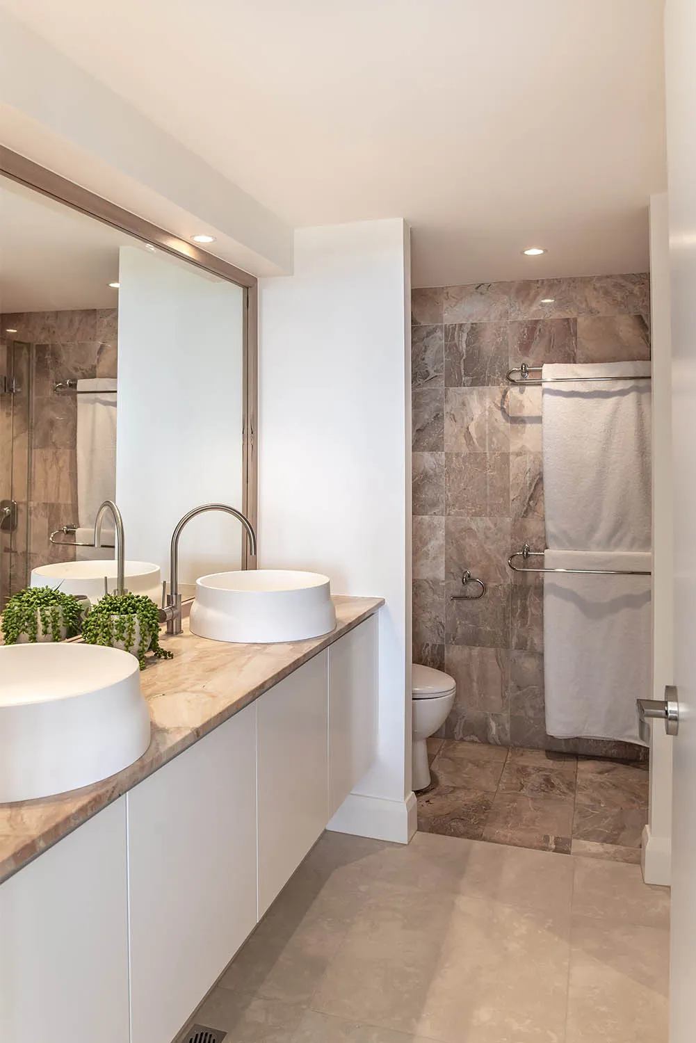 Bathroom with double vessel basins, stone benchtop and tiled walk-in shower